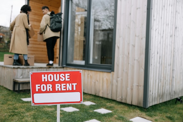 Red and White Signage Outside the House
